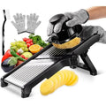 Black stainless steel mandoline slicer with food holder slicing a potato
